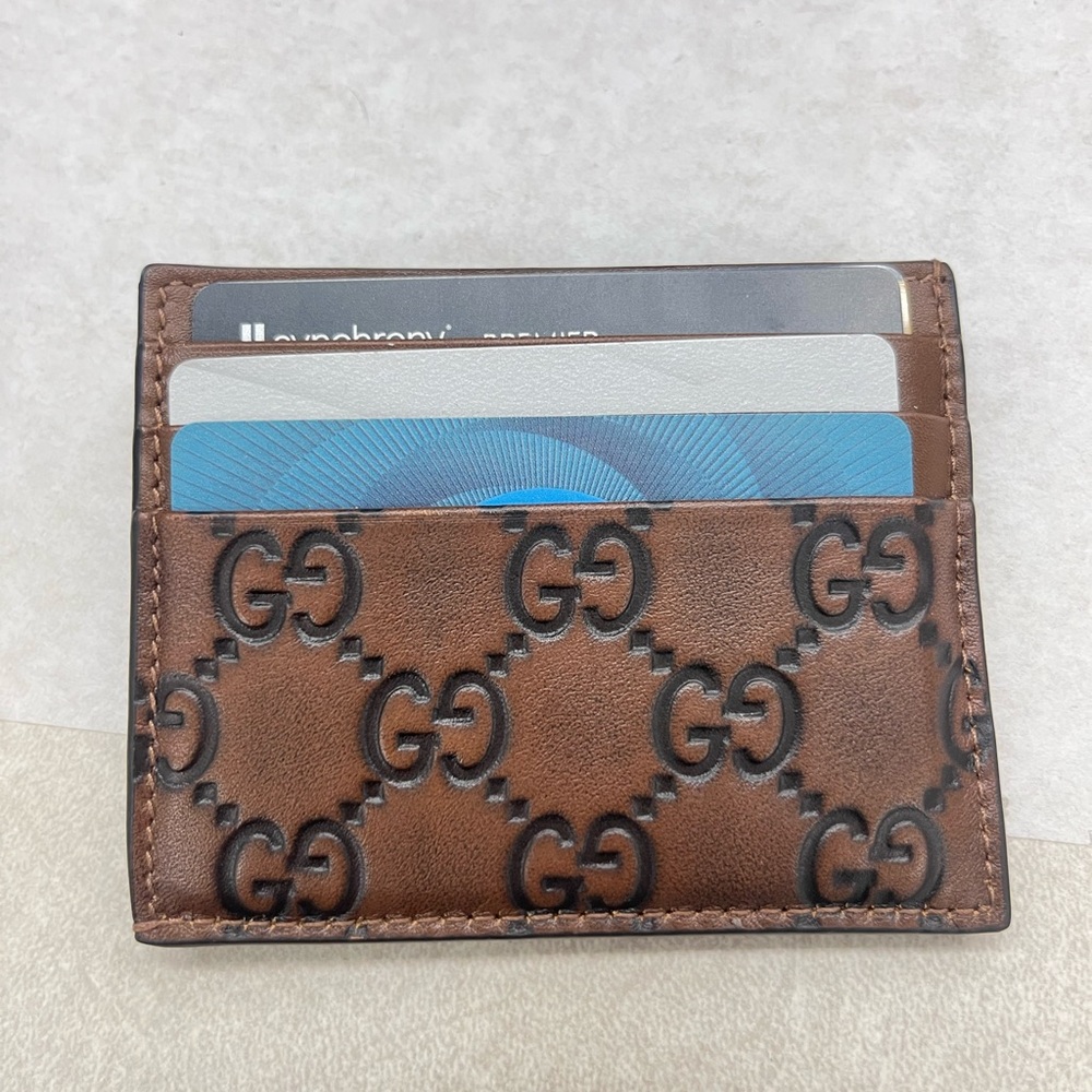Like NEW and authentic Gucci Brown GG Embossed Leather Card Holder. Beautiful!